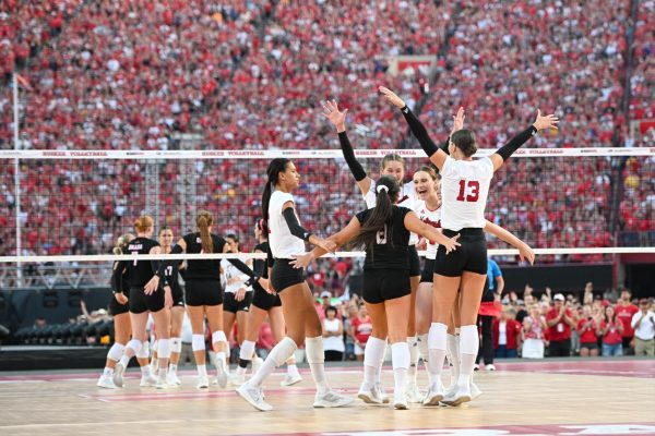 Nebraska women's volleyball celebrating after their first set win against the Omaha Mavricks. -Steven Branscombe/Getty Images