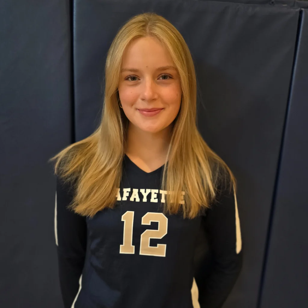 Emma smiles happpily at her volleyball photos!