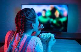 The blue light from the screen fills the room with a comforting glow of the TV.
