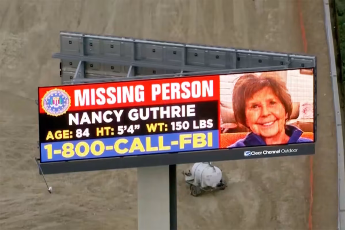 A missing person billboard featuring Nancy Guthrie asking for help.