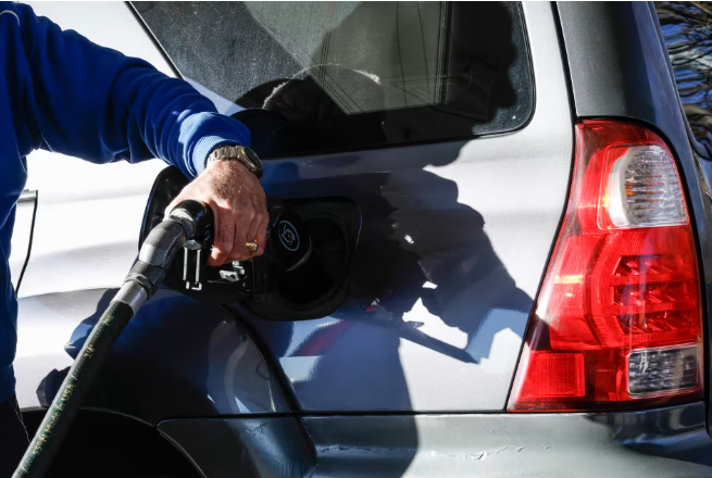 Americans pumping gas after the surge in prices